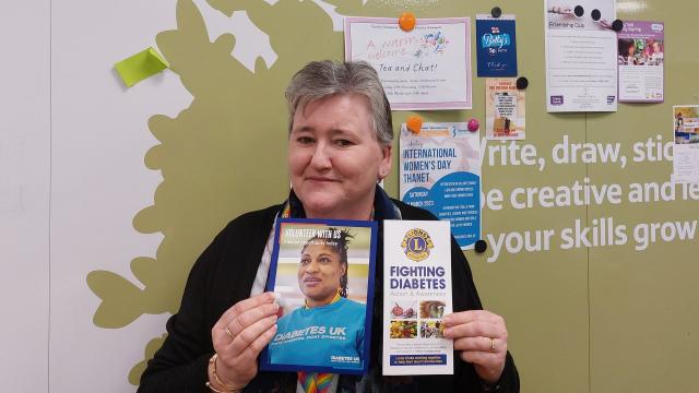 Woman holding diabetes awareness leaflets