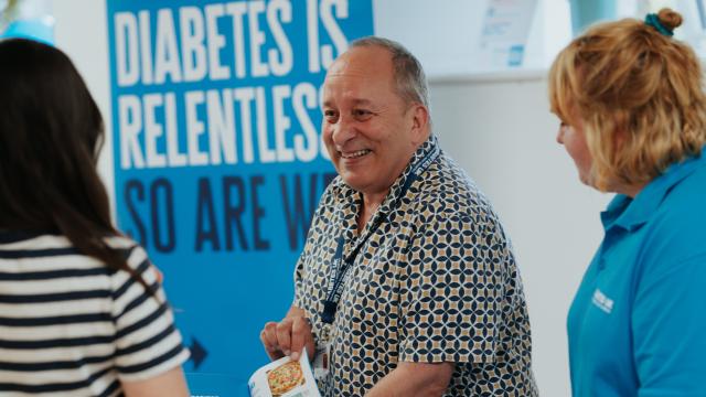 Man next to Diabetes UK banner