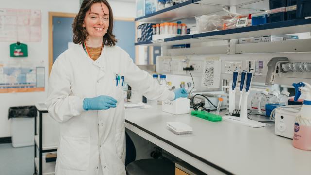 researcher looking at camera in her laboratory