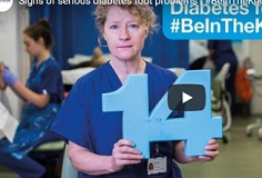 Clinical member Maureen holds up the number 14
