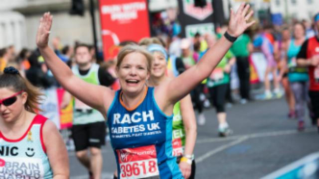 A lady running for Diabetes UK at a running event