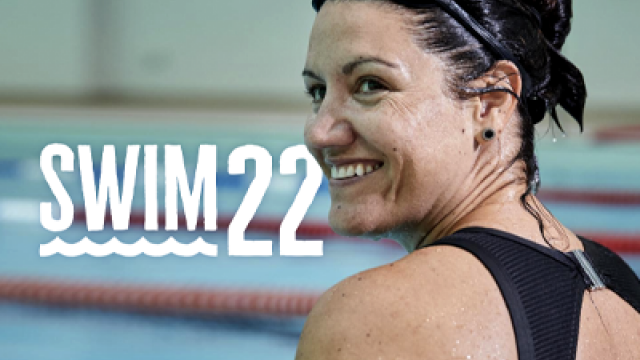 A smiling woman in a swim suit and goggles sits on the edge of a swimming pool. White text reads 'Swim 22'